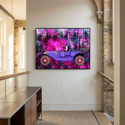 Going for a Spin (fuchsia) van Tim Hupkes in een zwarte lijst aan de muur van een hal bij bakstenen muren, een pinguïn in een paarse auto