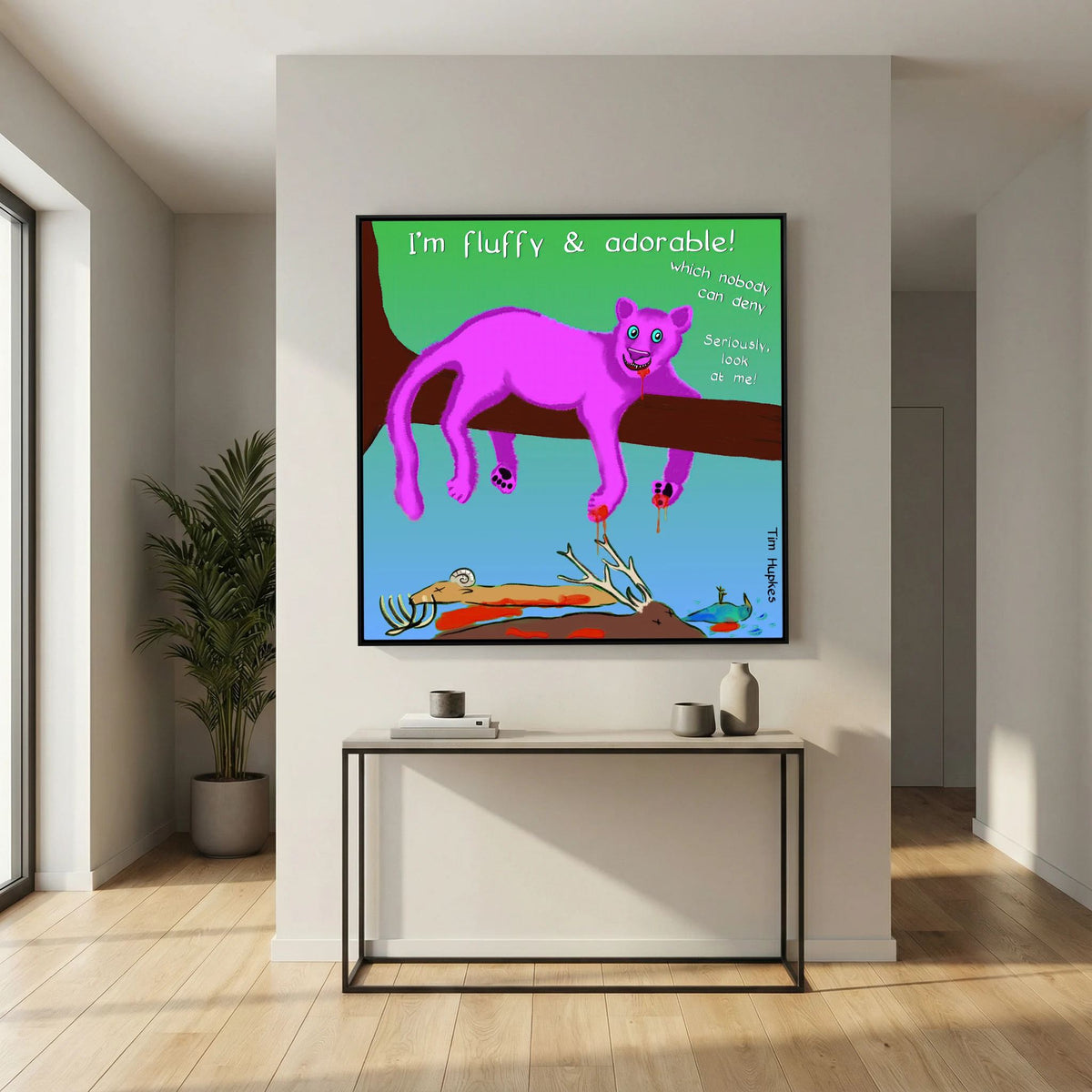Fluffy Pink Panther by Tim Hupkes in a black frame above a slim console table in a bright hallway with a palm