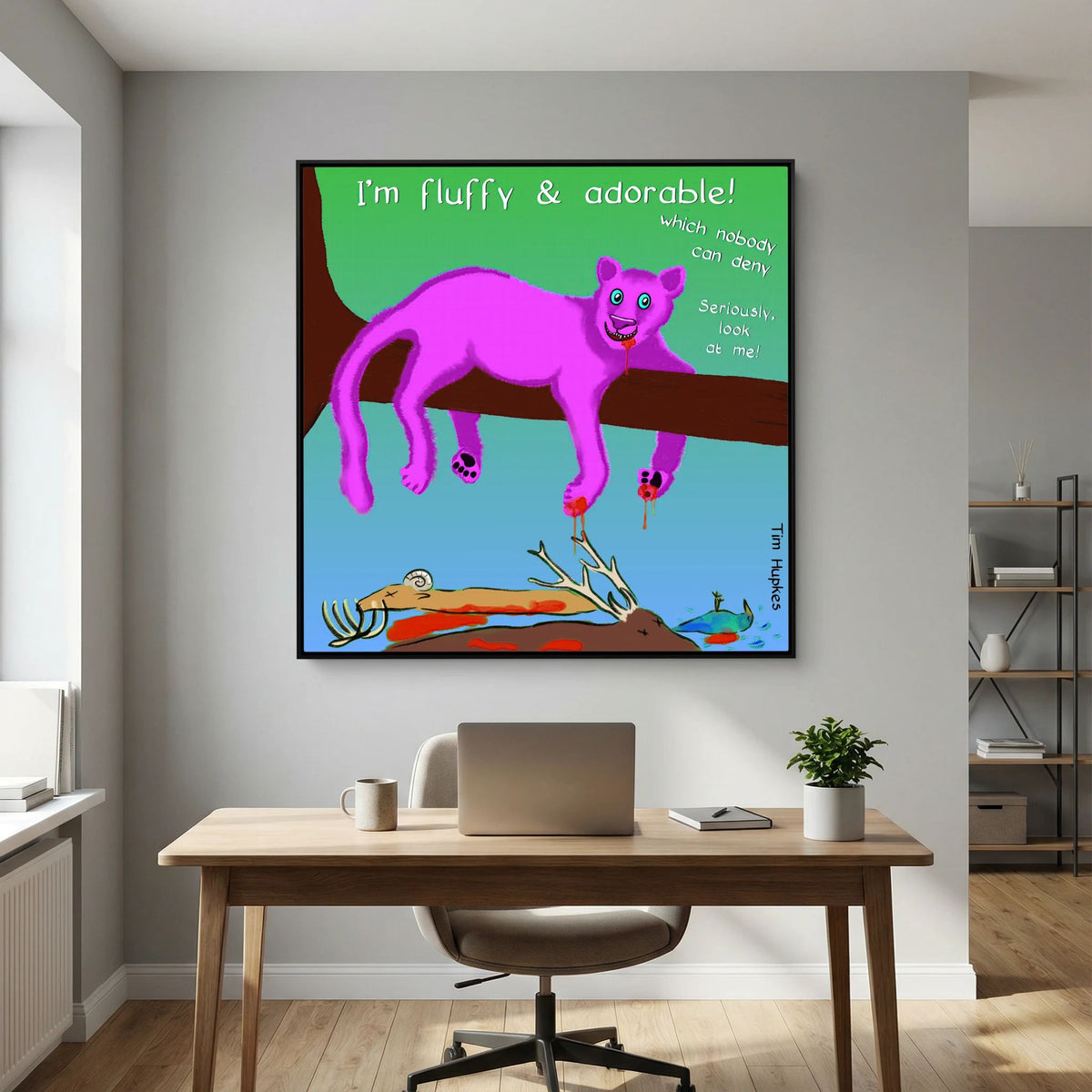 Black-framed Fluffy Pink Panther by Tim Hupkes above a desk with laptop and plant beside shelving in a study