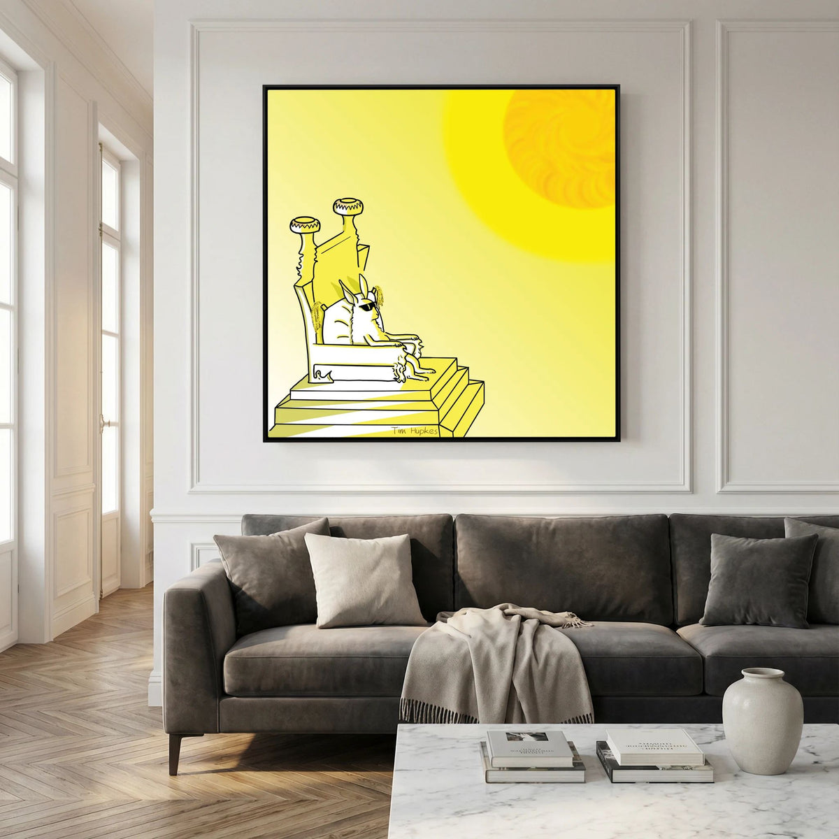 Large black-framed Royal by Tim Hupkes canvas print above a dark grey sofa in a living room with panelled white walls