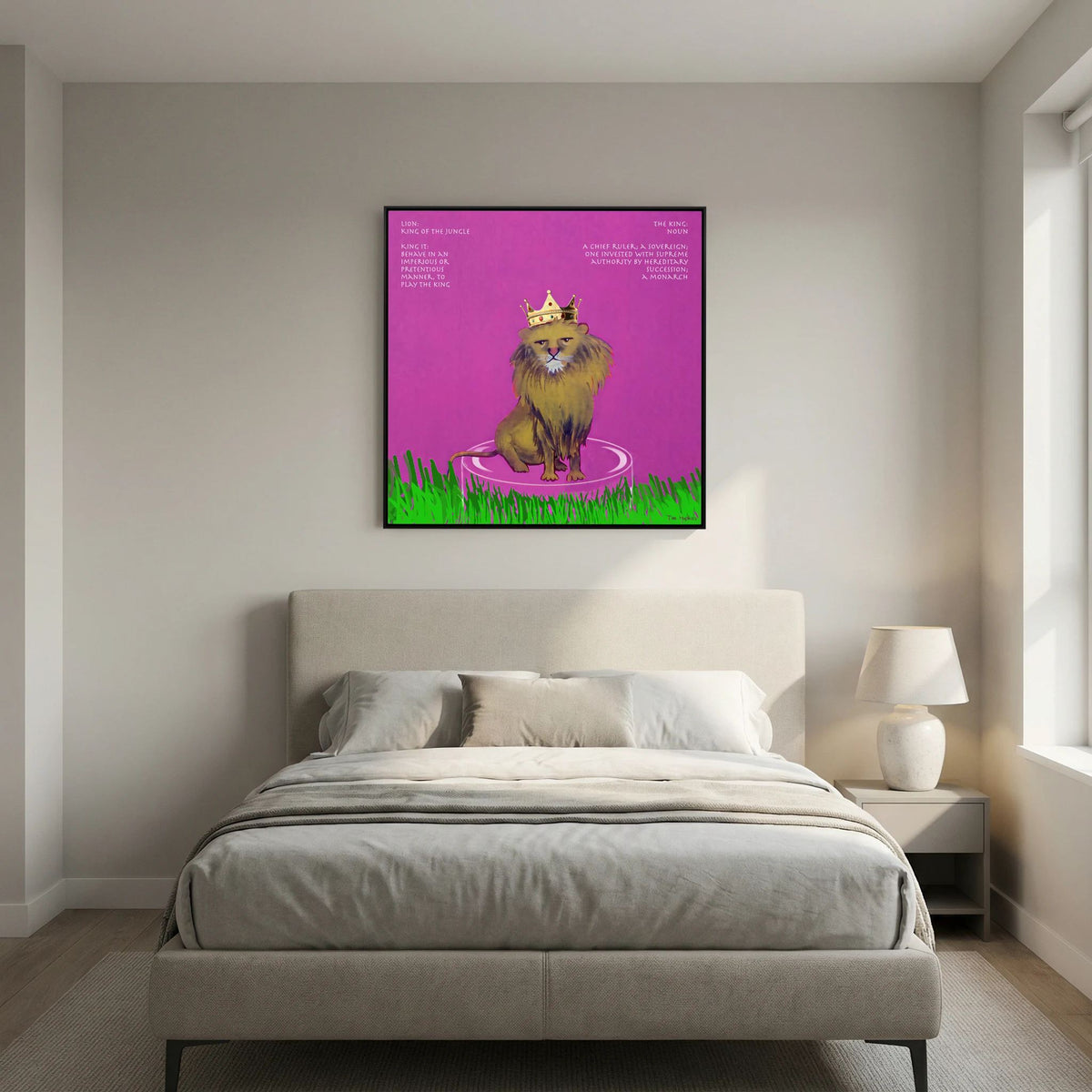 The King canvas print in a black frame above a beige bed with grey bedding in a bedroom