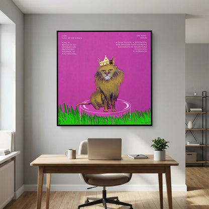 The King canvas print in a black frame above a wooden desk with a laptop in a home office