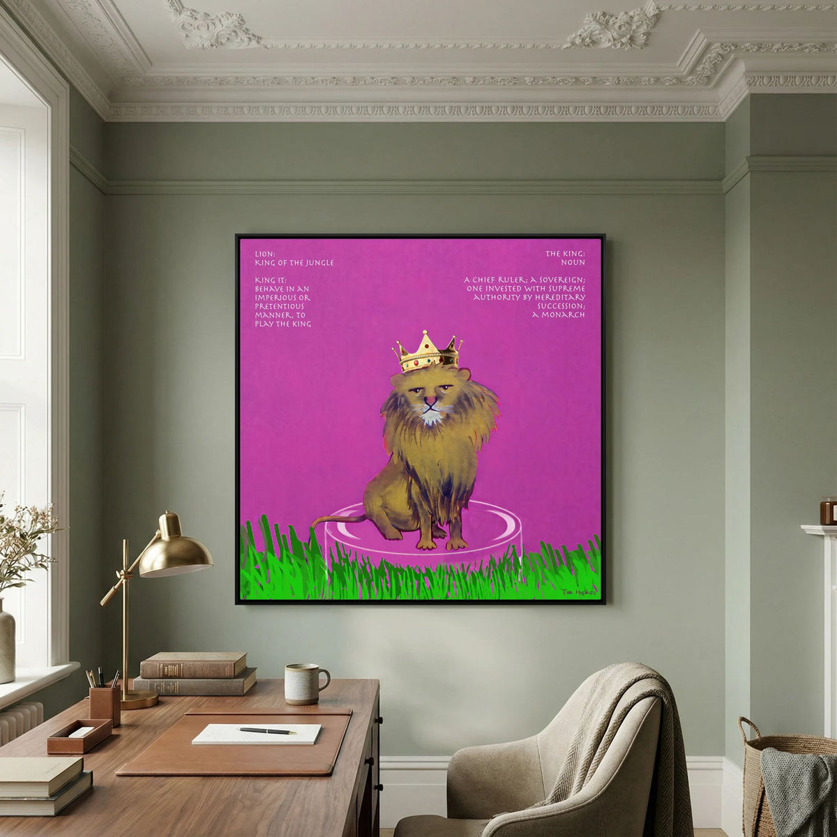 The King canvas print in a black frame above a wooden desk in a study with green walls