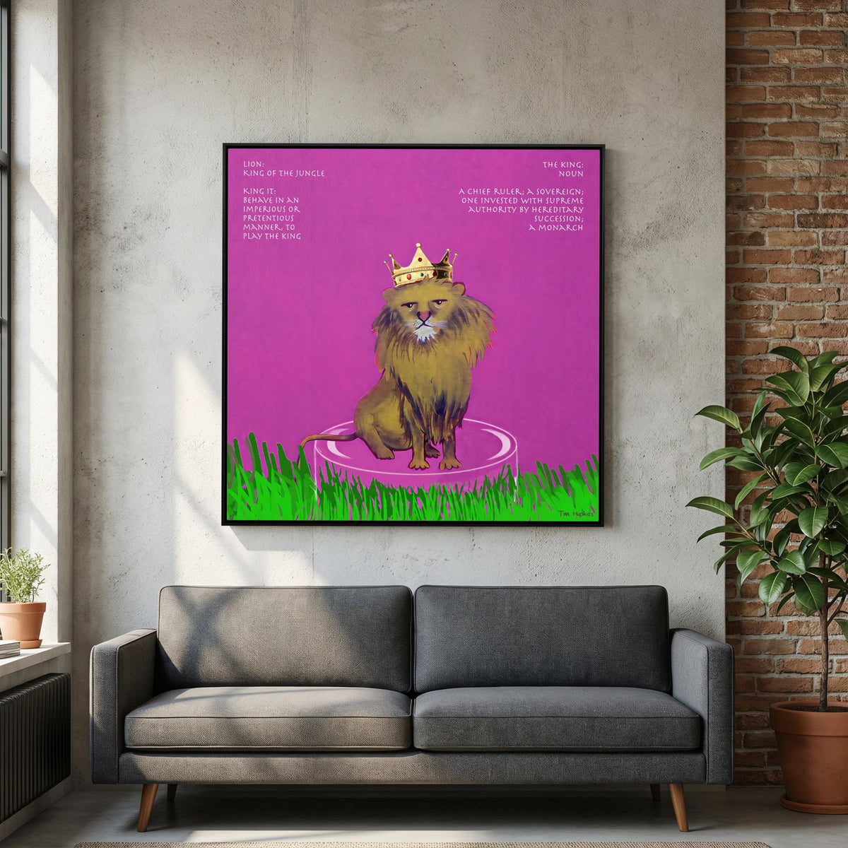The King canvas print in a black frame above a grey sofa next to a brick wall in a living room