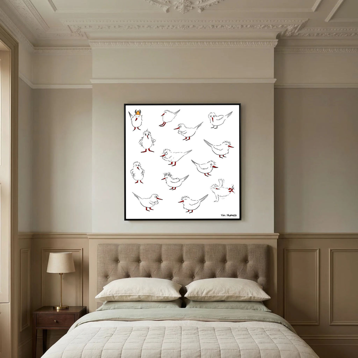 Black-framed Blackburn & Haptoe - everyday heroes by Tim Hupkes hanging above a tufted headboard in a traditional bedroom with panelled walls