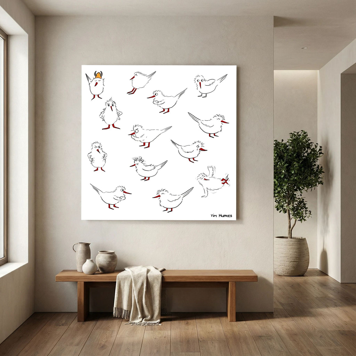 Unframed Blackburn & Haptoe - everyday heroes by Tim Hupkes canvas print hanging above a wooden bench in a bright hallway with a potted tree