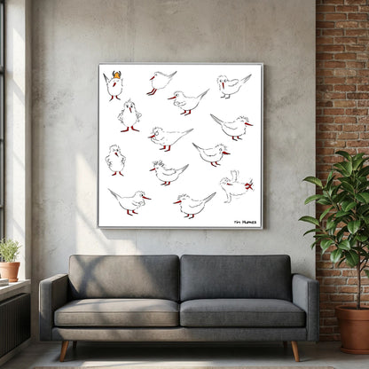White-framed Blackburn & Haptoe - everyday heroes by Tim Hupkes above a grey sofa, with a concrete wall and brick wall in the room