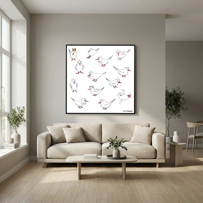 Black-framed Blackburn & Haptoe - everyday heroes by Tim Hupkes above a cream sofa in a living room with large windows