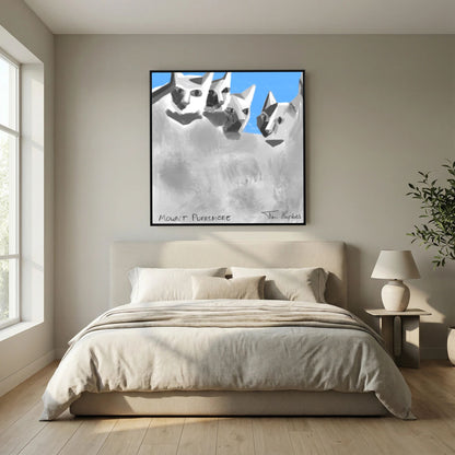 Black-framed Mount Purrsmore by Tim Hupkes canvas print hanging above a bed with cream bedding, beside a bedside table and a lamp