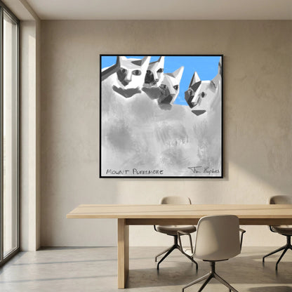 Black-framed Mount Purrsmore by Tim Hupkes canvas print on a beige wall behind a long wooden dining table with pale chairs