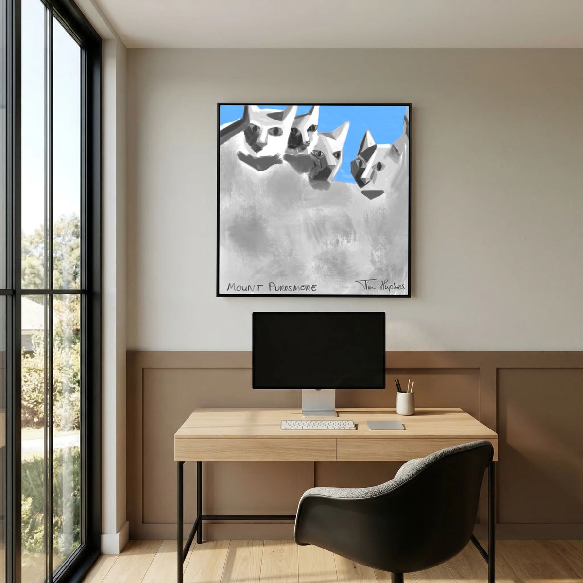 Black-framed Mount Purrsmore canvas print by Tim Hupkes hanging above a wooden desk with a monitor and a dark chair