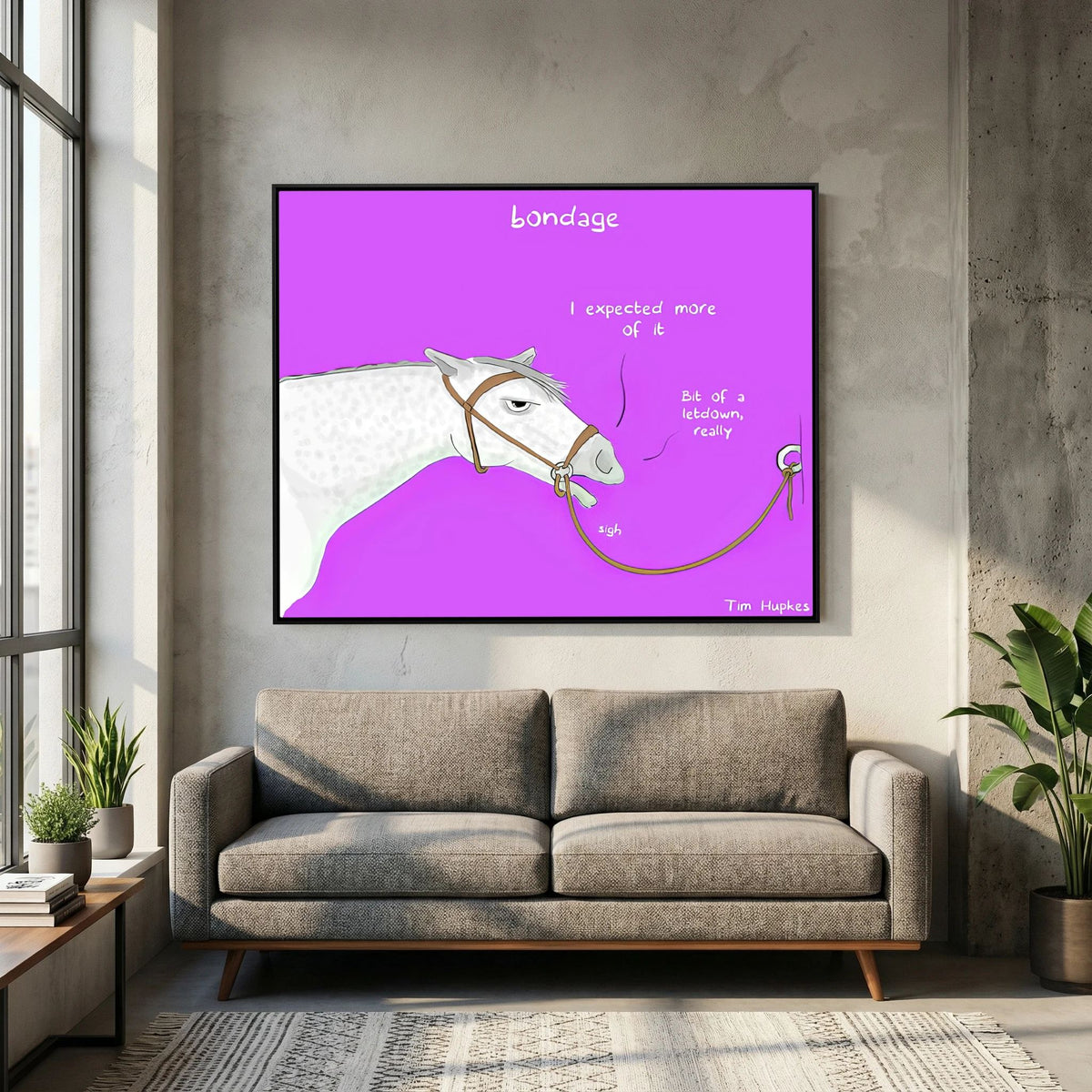 Bondage canvas print in a black frame above a grey sofa in a loft living room with concrete wall
