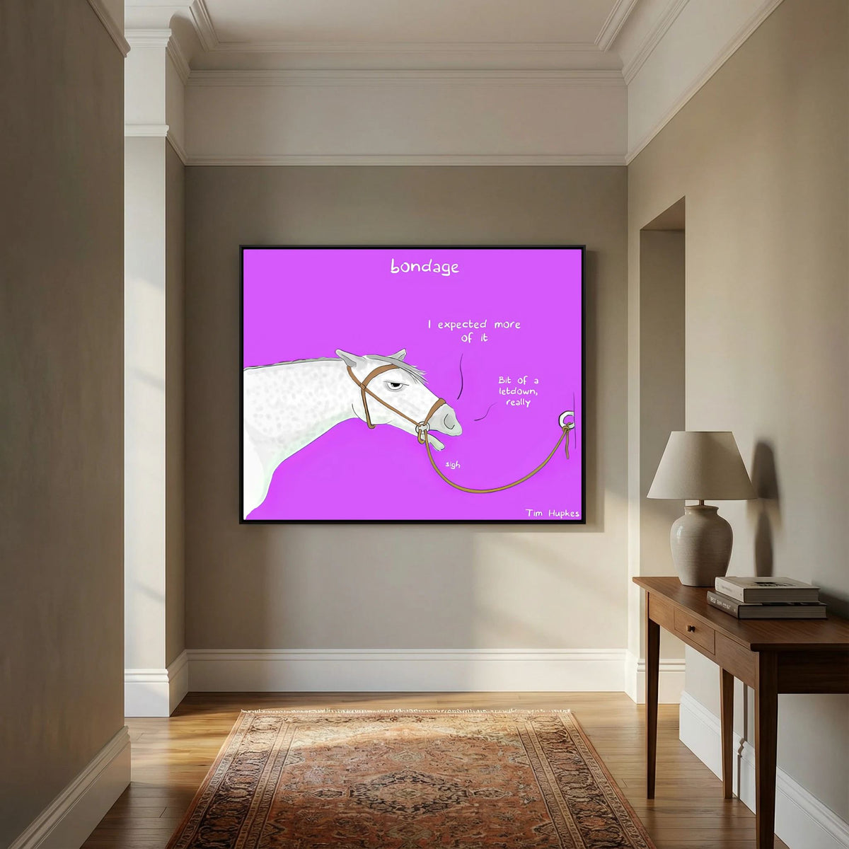 Bondage canvas print in a black frame on a hallway wall beside a wooden console table