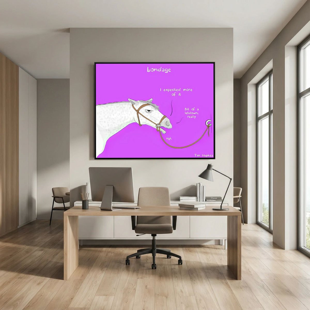 Bondage canvas print in a black frame above a light wooden desk with a monitor in an office