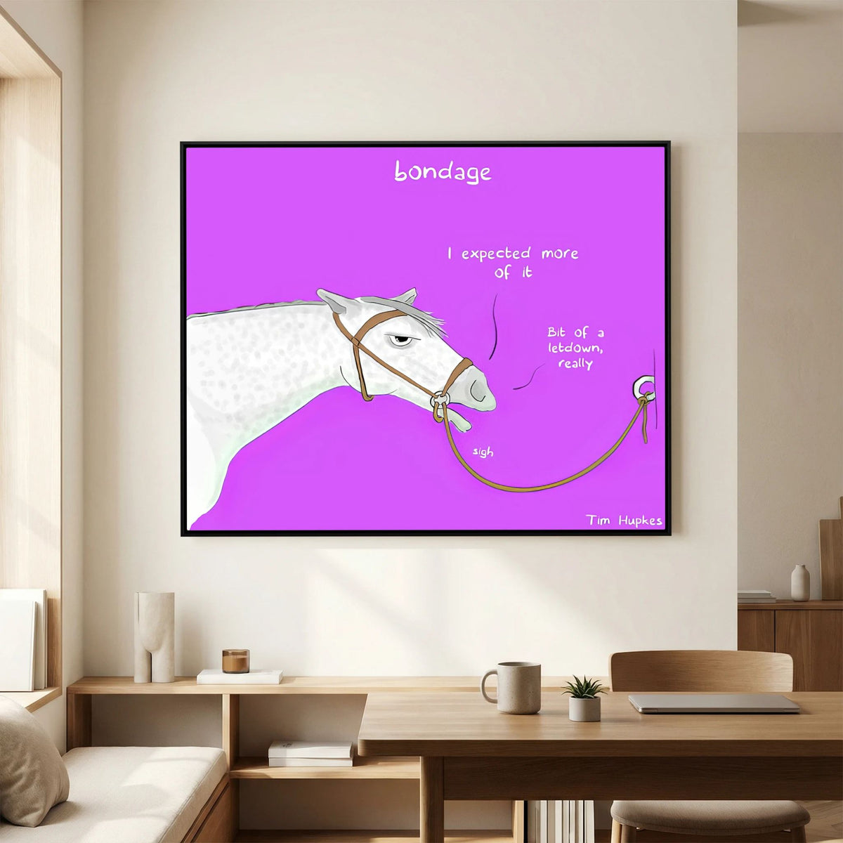 Bondage canvas print in a black frame above a wooden desk and shelves in a home office